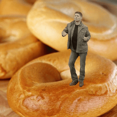 Man Standing On A Bagel In Front Of Bagels GIF