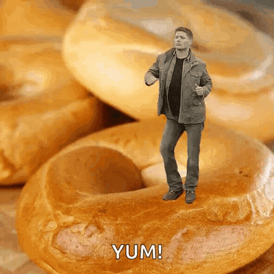 Man Standing On Bagel Saying Yum GIF