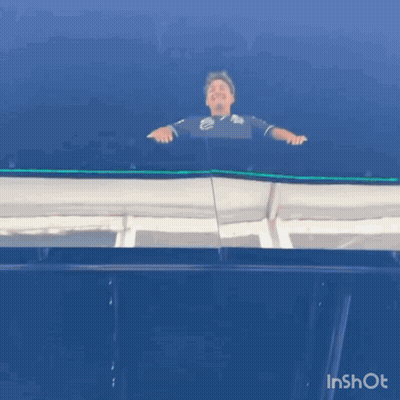 Man Standing On Balcony With Blue Sky GIF