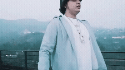 Man Standing On Balcony With Mountains GIF