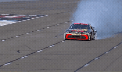Man Standing On Bass Pro Race Car GIF