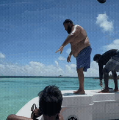 Man Standing On Boat In Ocean GIF