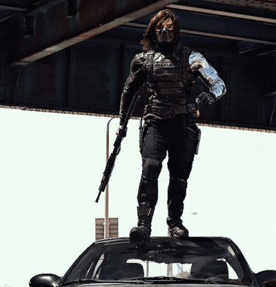 Man Standing On Car With Gun GIF