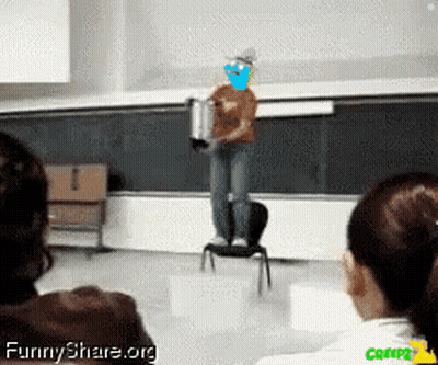 Man Standing On Chair In Front Of Blackboard With Funnyshare.org GIF