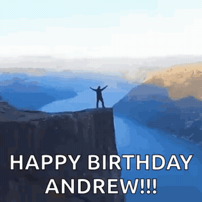 Man Standing On Cliff Overlooking Water GIF