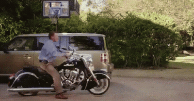 Man Standing On Motorcycle In Front Of Van GIF