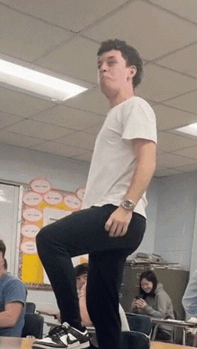 Man Standing On One Leg In Classroom GIF