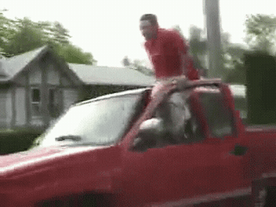 Man Standing On Red Truck Roof GIF
