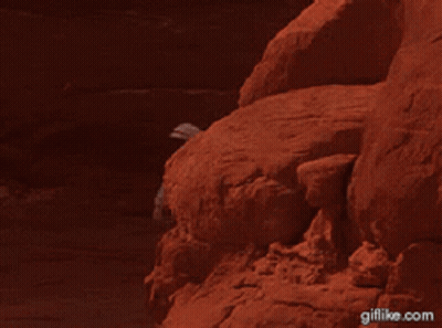 Man Standing On Rock Giflike.com GIF