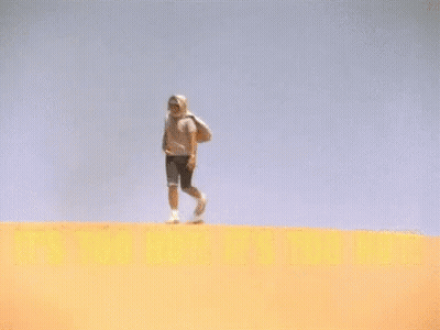 Man Standing On Sand Dune Saying It's Too Hot GIF