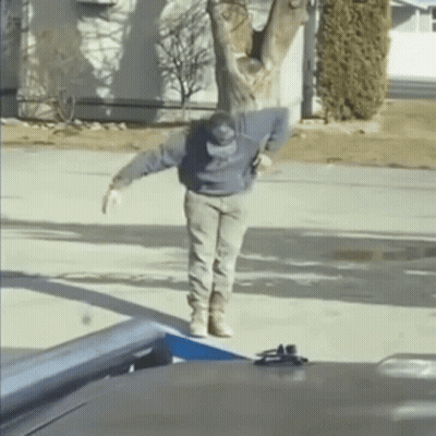 Man Standing On Sidewalk In Front Of House GIF