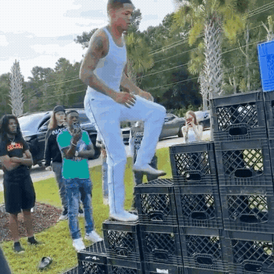 Man Standing On Stack Of Milk Crates GIF