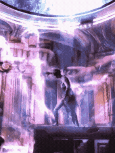 Man Standing On Stage With Purple Light GIF