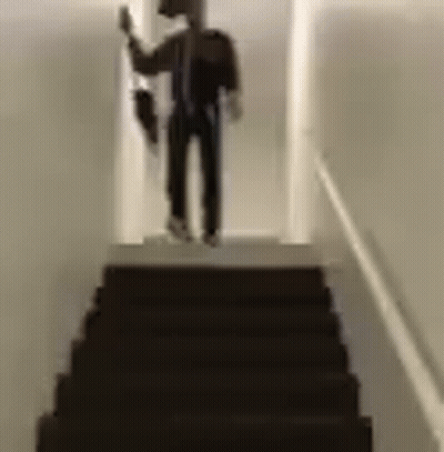 Man Standing On Stairs Holding Umbrella GIF