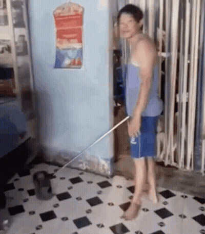 Man Standing On Tiled Floor With Mop GIF