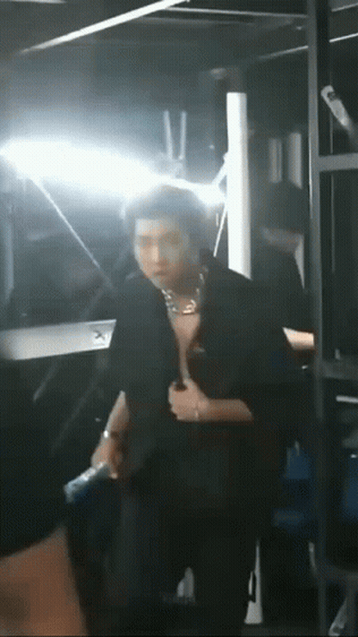 Man Standing Shirtless In Front Of Mirror In Dark Room GIF
