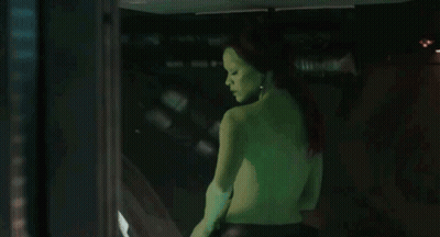 Man Standing Shirtless Showing Abs GIF