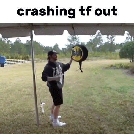 Man Standing Under Umbrella Holding Batman Hat GIF