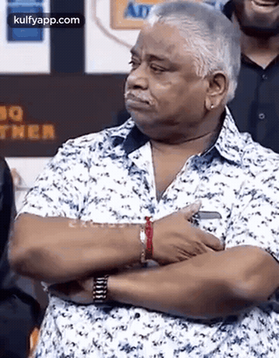 Man Standing With Arms Crossed In Front Of Crowd GIF