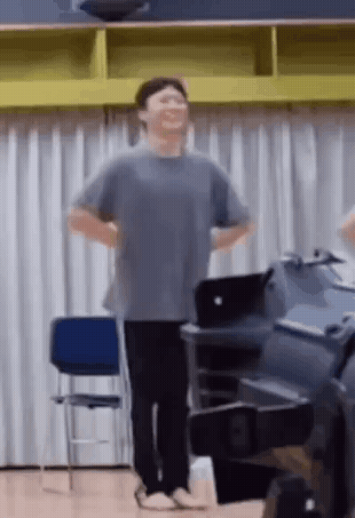 Man Standing With Hands On Hips Laughing GIF