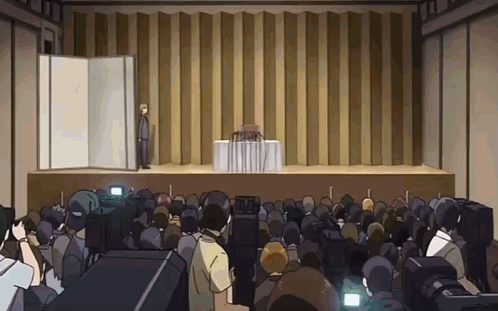 Man Stands On Stage In Front Of Large Crowd GIF
