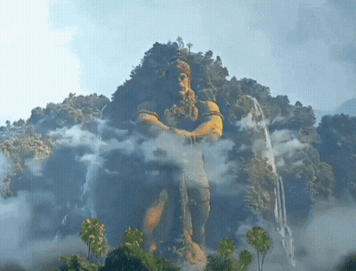 Man Statue On Mountain With Trees And Clouds GIF