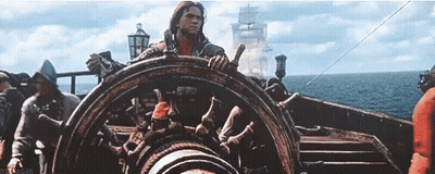 Man Steering Boat In Ocean GIF