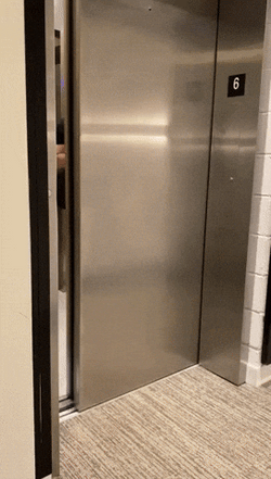 Man Stepping Out Of Elevator GIF