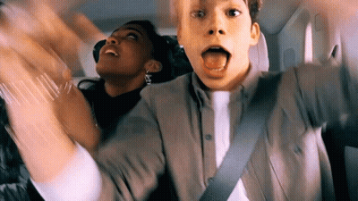 Man Sticking Tongue Out In Car Back Seat GIF