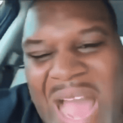 Man Sticking Tongue Out In Car Making Funny Face GIF