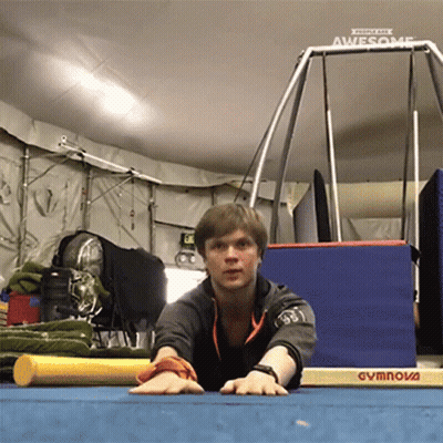 Man Stretching On Gymnova Mat In Gym GIF