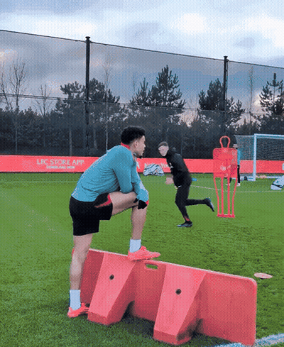 Man Stretching On Soccer Field With LFC App Ad GIF