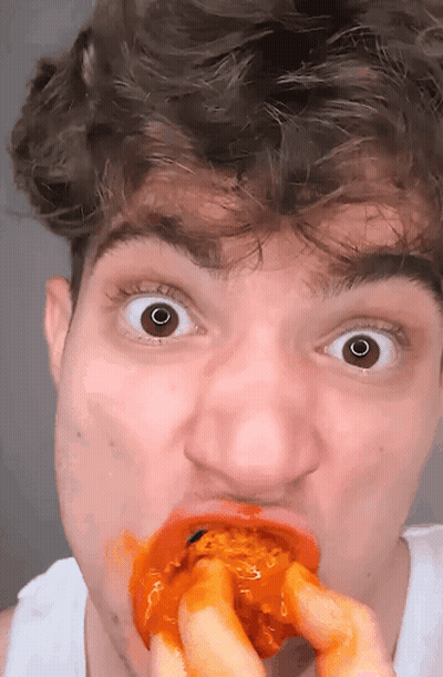 Man Surprised Eating Chicken Wing GIF