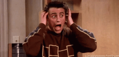 Man Surprised Holding Head In Kitchen GIF