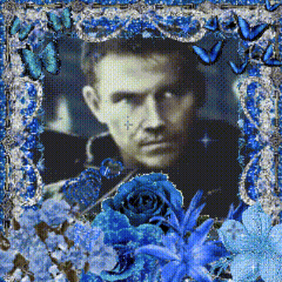 Man Surrounded By Blue Flowers And Butterflies GIF