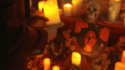 Man Surrounded By Candles And Skull GIF