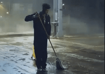 Man Sweeping Floor With Mop And Yellow Safety Cone GIF