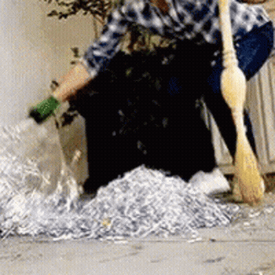 Man Sweeping Shredded Paper GIF