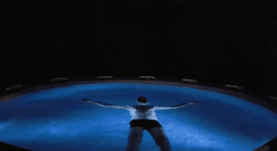 Man Swimming In Pool At Night GIF