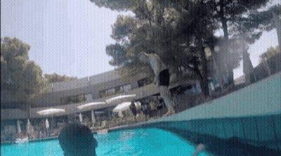 Man Swimming In Pool With Trees GIF