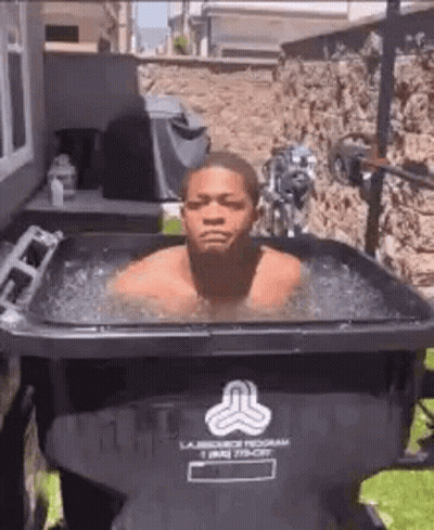 Man Swimming In Trash Can With Ice GIF