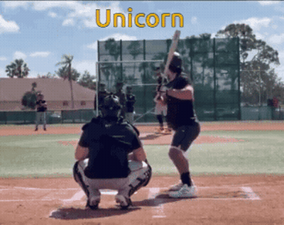 Man Swinging Bat On Baseball Field GIF