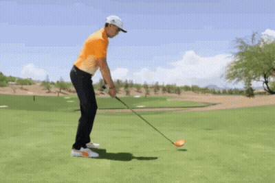 Man Swinging Golf Club At Ball GIF