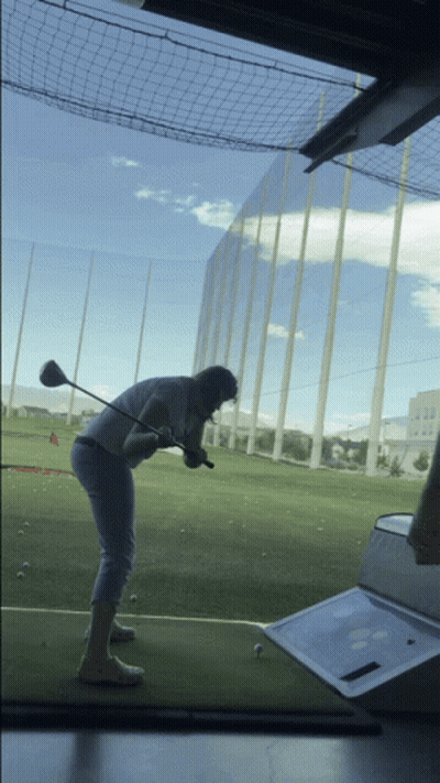 Man Swinging Golf Club At Ball GIF