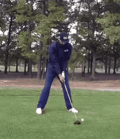 Man Swinging Golf Club At Ball GIF