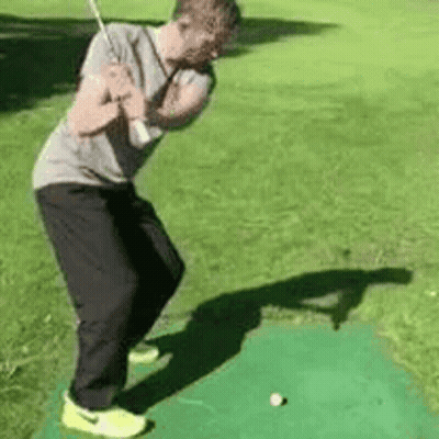 Man Swinging Golf Club At Golf Ball GIF