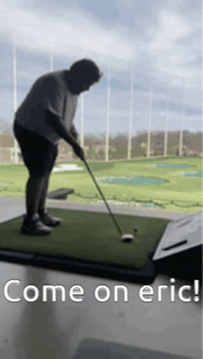 Man Swinging Golf Club at Golf Ball