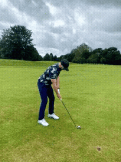Man Swinging Golf Club At Golf Ball GIF