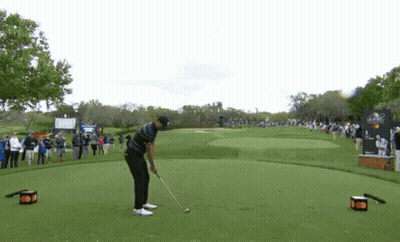 Man Swinging Golf Club At Golf Ball GIF