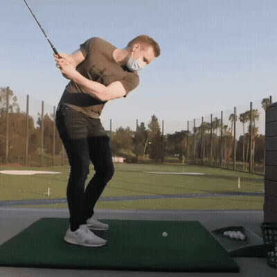 Man Swinging Golf Club In Mask GIF